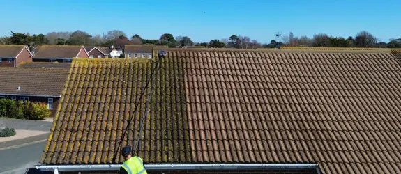 one of our skilled technicians carrying out professional roof cleaning in Swindon