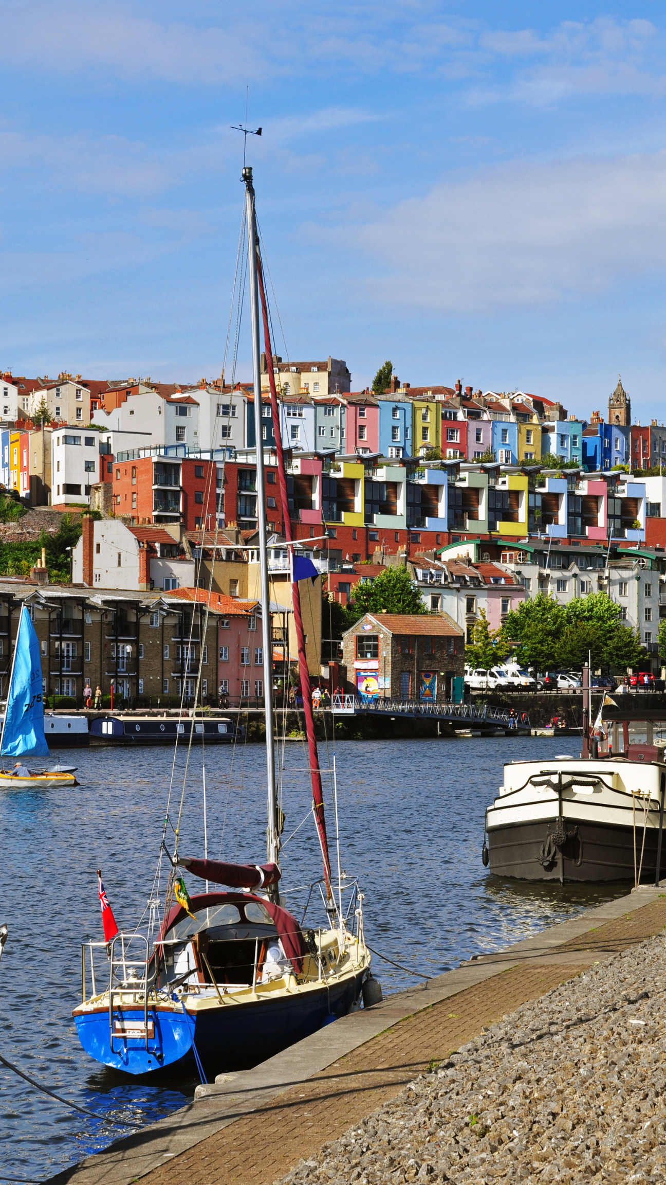 This portrait image shows a riverside area of Bristol with the purpose of portraying an idea of what gutter cleaners commonly deal with in the area.