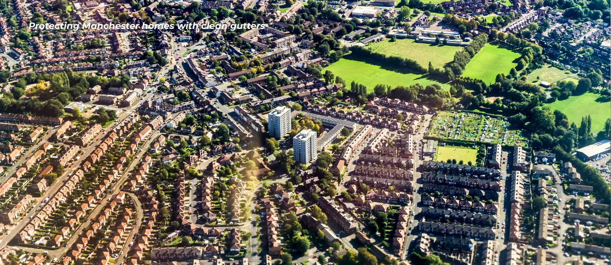 This is an aerial drone shot showing a large scale urban surrounding of Manchester, a good fraction of it being suburban houses that gutter cleaners tend to commonly clean in the area.
