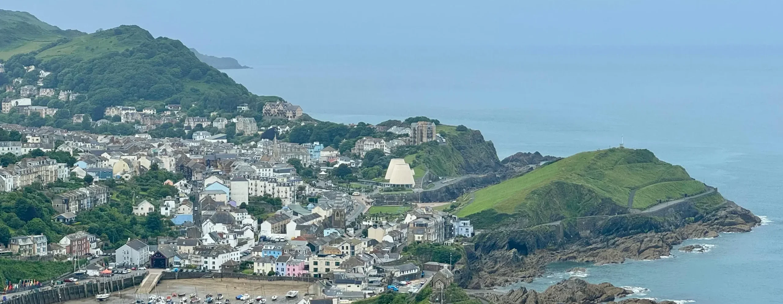 An urban aerial shot showing Ifracombe, a coastal area located in Devon, this is to provide locational context and decorative purposes