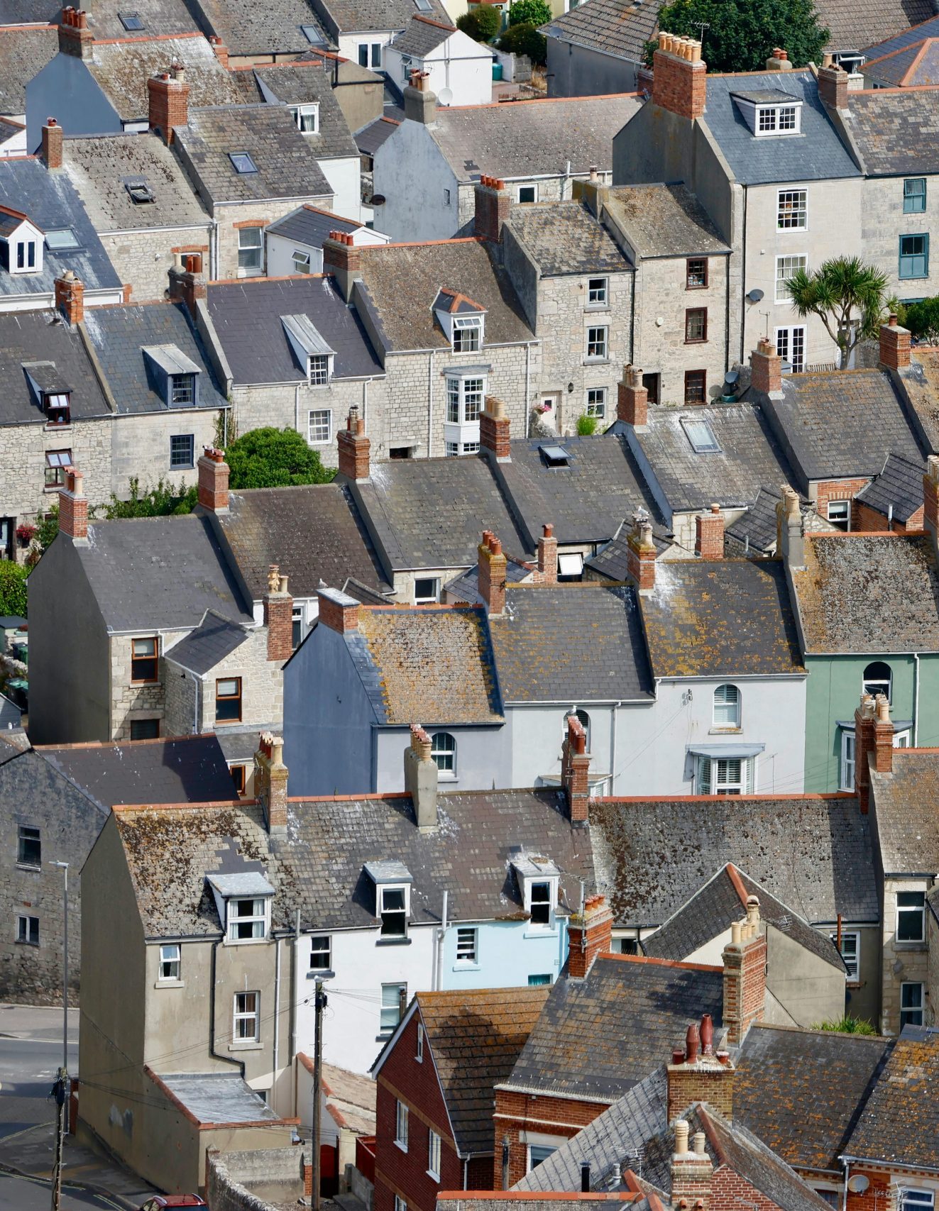 A hill of houses displayed in Dorset, this is showing a good amount of gutters that gutter cleaners can go and clean.