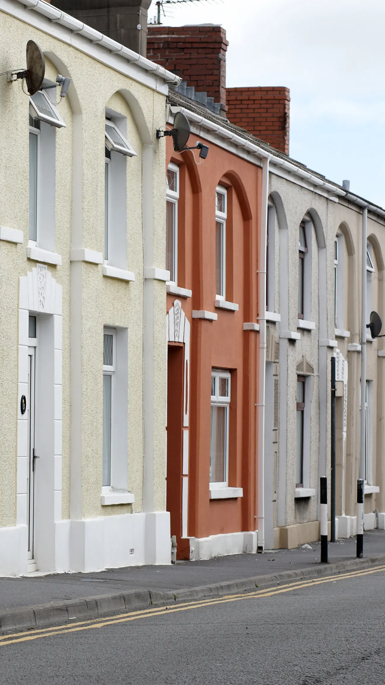 A portrait image showing a street in Cheshire with gutters that need clearing out.
