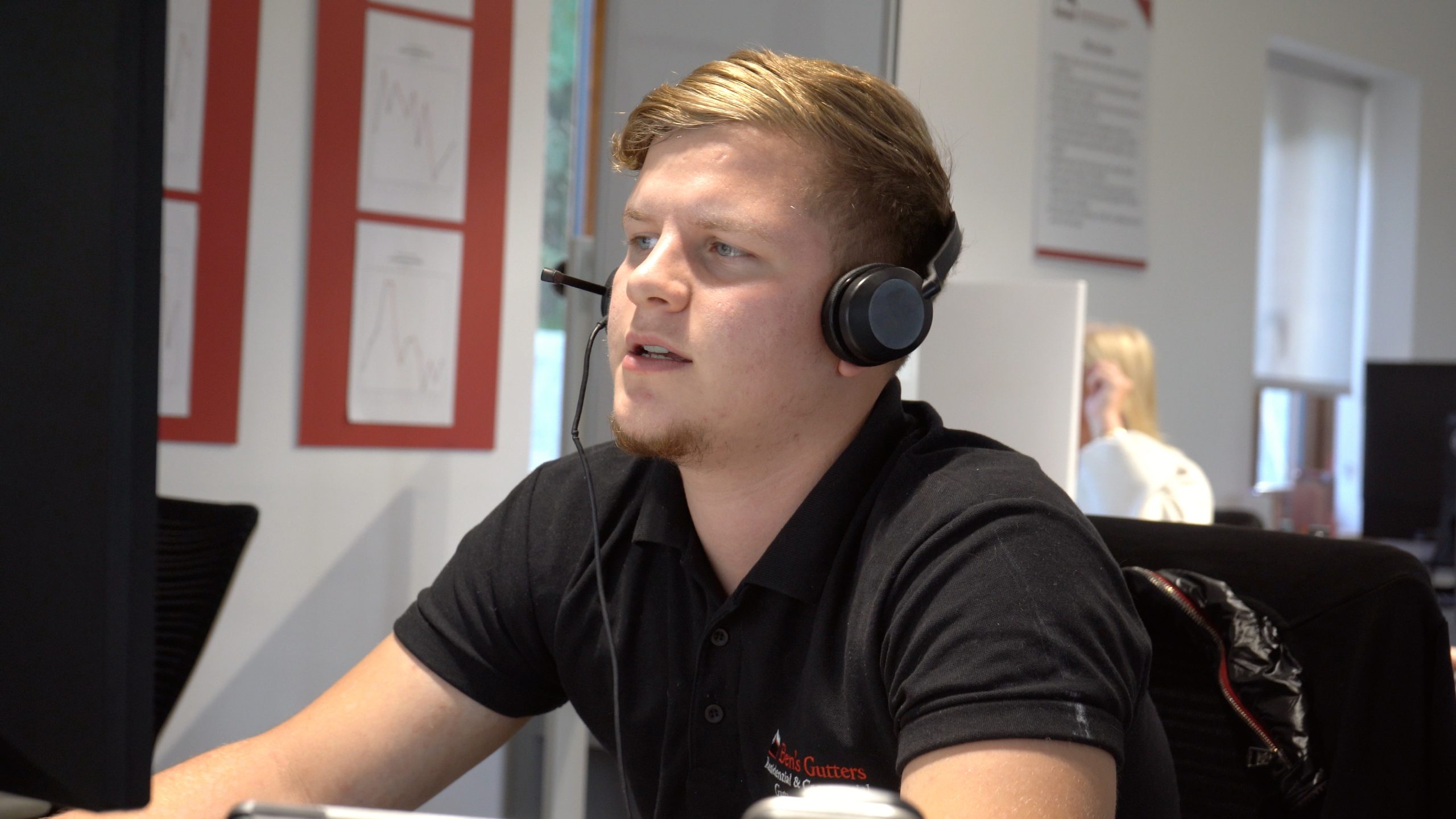office employee with headsets on working out a quote